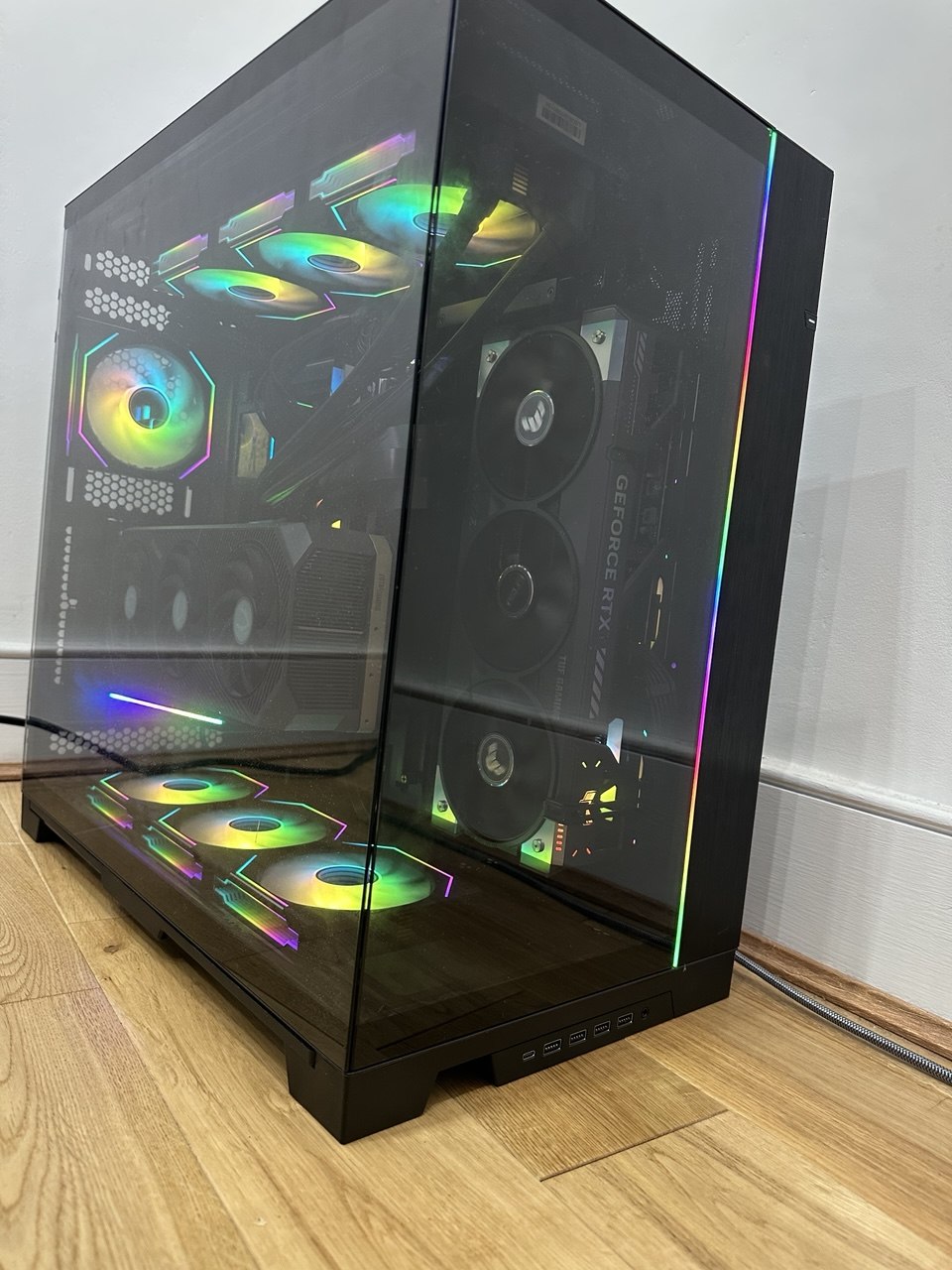 The finished build with both tempered glass panels fitted, seven RGB fans and both graphics cards visible through the glass
